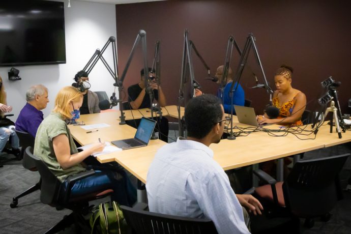 Members of the Building an Institute for Empathic Immersive Narrative team sit around a table with microphones, recording a podcast at Virginia Polytechnic Institute & State University.