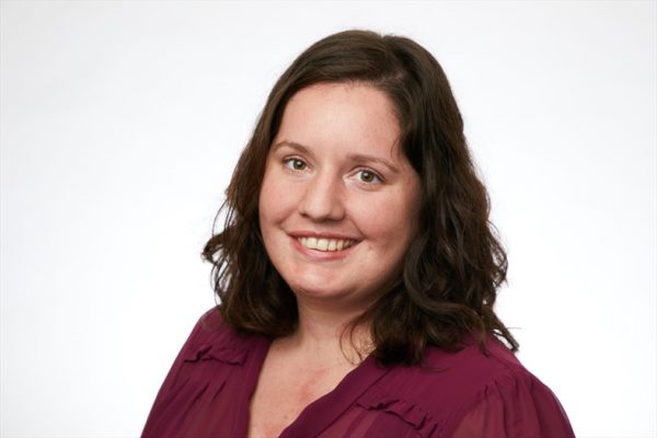 Headshot of Laura Mowry in maroon shirt