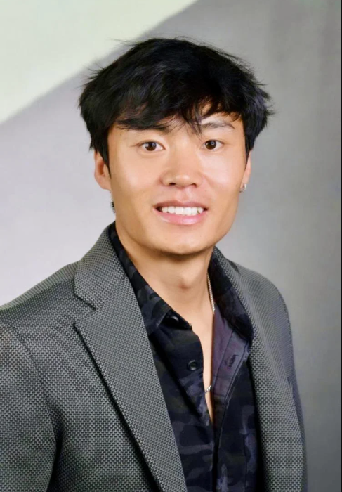 Headshot of Sanggay Tashi in gray suit