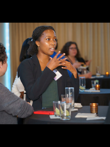 Moriah King, a collaborator of Jon Anjaria, 2018 Scholars and Society fellow, speaking with others at the lunch event celebrating Preparing Publicly Engaged Scholars at NHC.