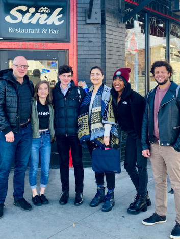 Nandi Pointer, a collaborator of Sandra Ristovska, 2021 Scholars and Society fellow, standing outside a restaurant with friends and colleagues.
