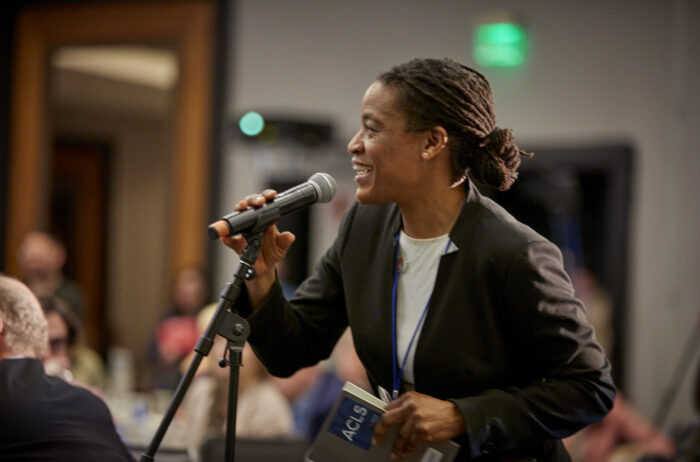An event attendee speaking into a microphone at a Q&A session at the 2025 ACLS Annual Meeting.